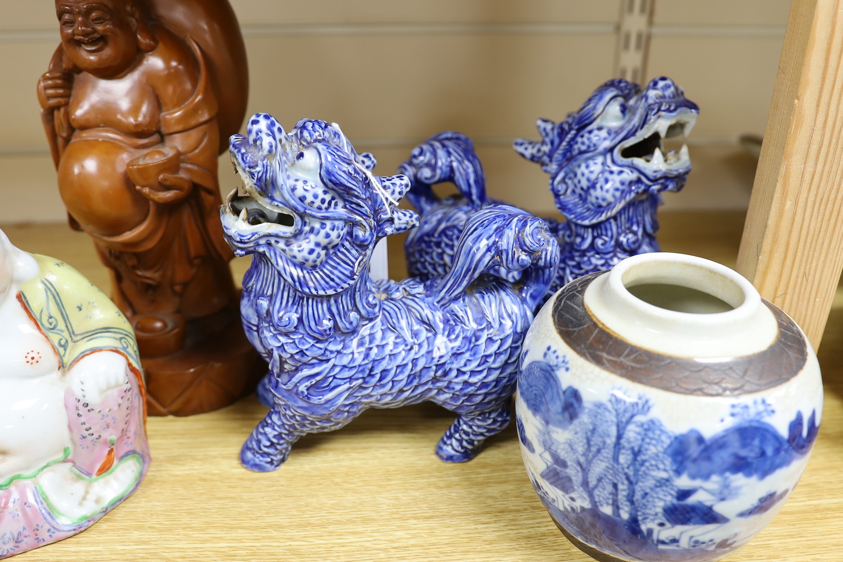 A pair of Chinese temple lions, two Buddha, 24cm high and a jar